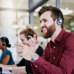 Image of contact centre focused on male talking on phone handset